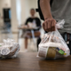 A student picks up a free individually bagged lunch in the cafeteria during the first day of school at Stamford High School on September 08, 2020, in Stamford, Connecticut.